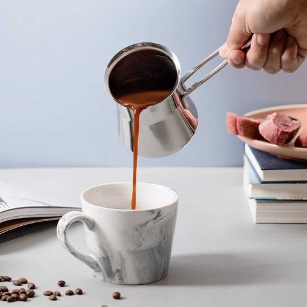 Caizen Coffee Sleek Arabic Coffee Pot pouring coffee into a mug
