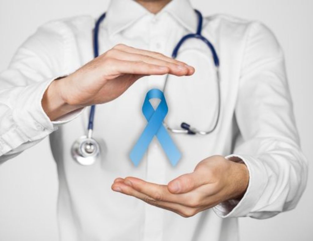 Doctor displaying cancer free blue ribbon