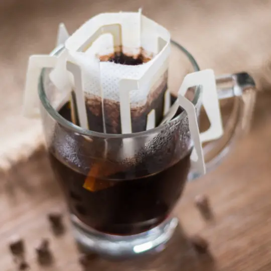 Pour over drip coffee filter brewing in a glass
