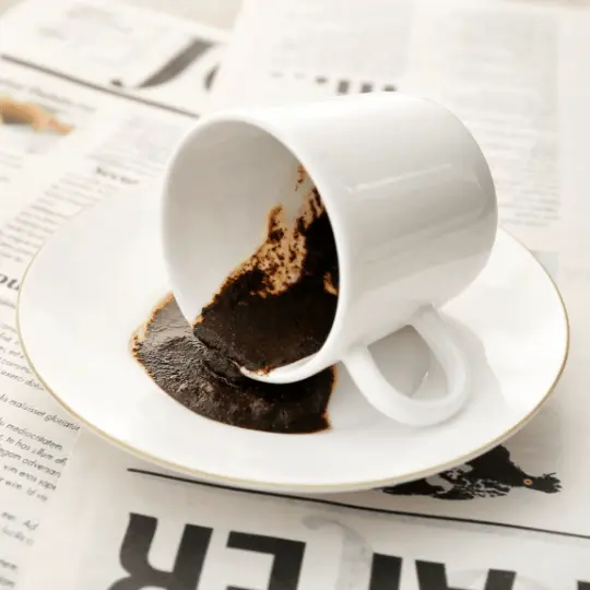 A white coffee cup on a saucer displaying a fortune reading